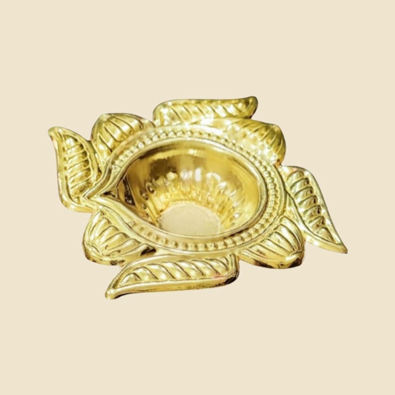 Brass Swastik Chirag on a warm ivory background