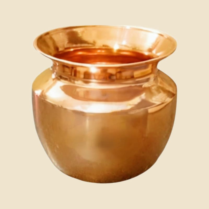 Brass Tirupur Loti on a warm ivory background