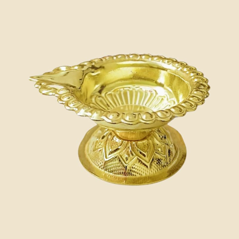 Brass Nakshi Stand Chirag on a warm ivory background