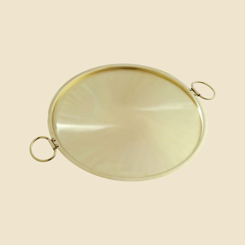 Brass Dosa Tawa on a warm ivory background