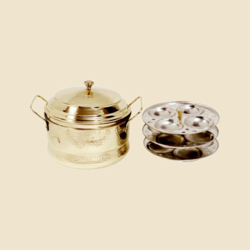 Brass Idli Cooker on a warm ivory background
