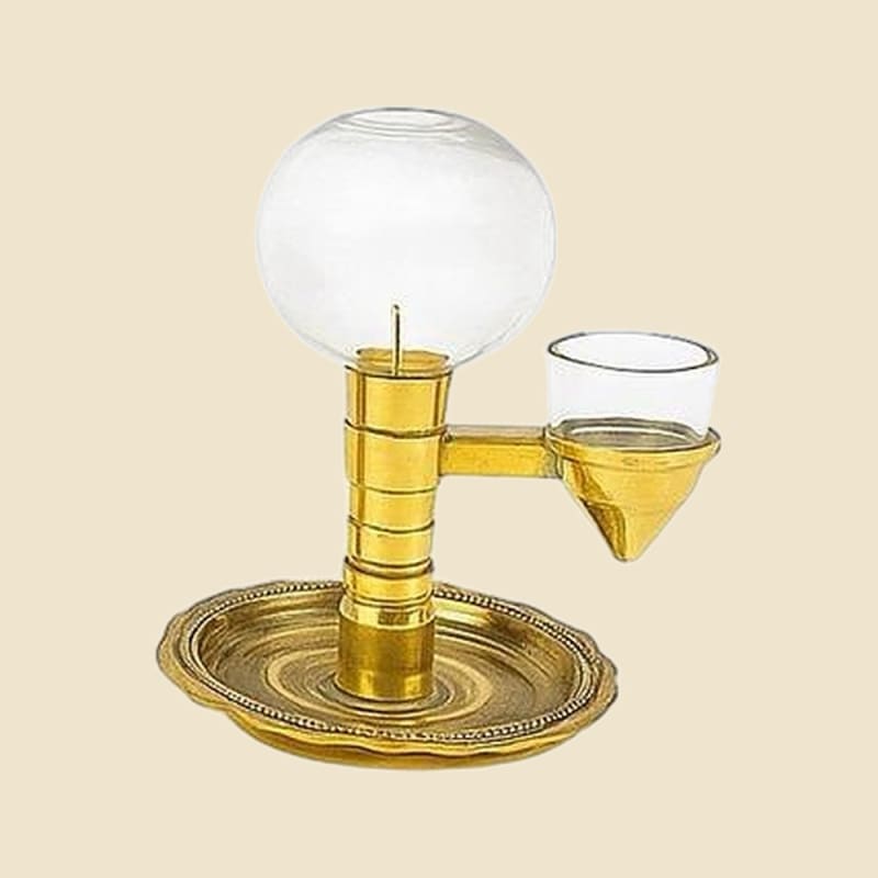 Brass and Glass Akhand Oil Lamp, 150 ml on a warm ivory background