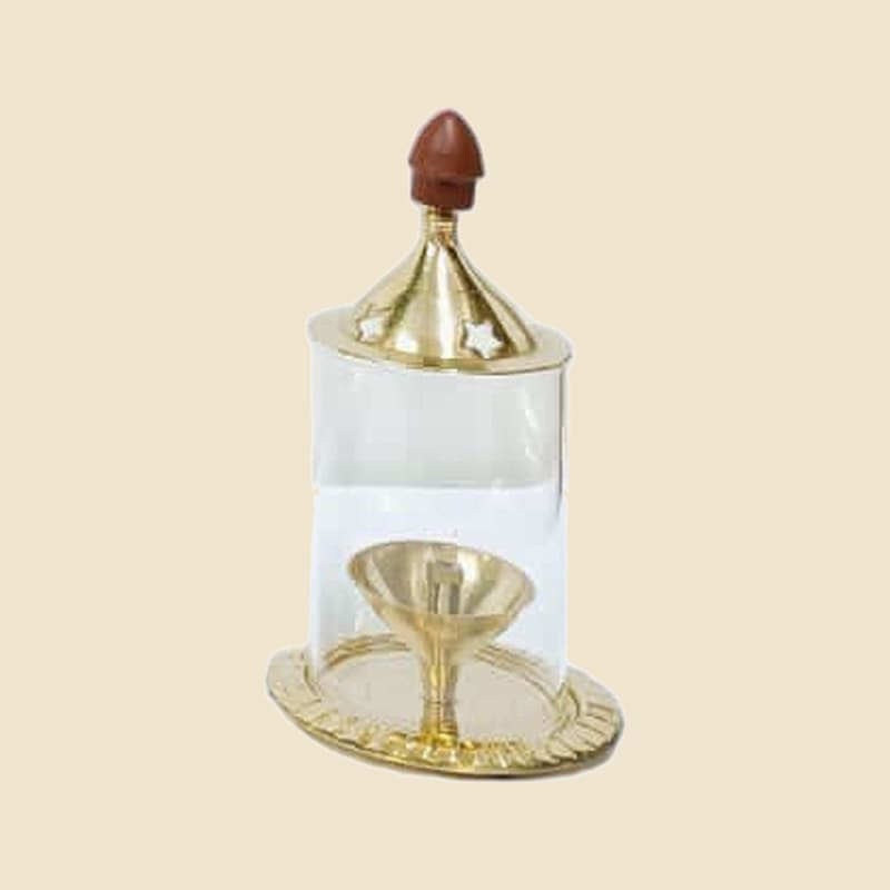 Brass Akhand Diya with Glass Dome, Small on a warm ivory background