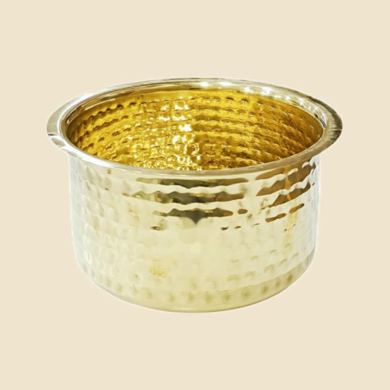 Hammered Brass Top (Patila) on a warm ivory background