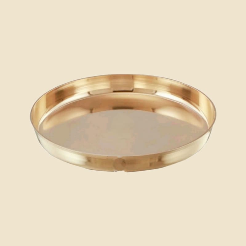 Pure Brass Plate on a warm ivory background