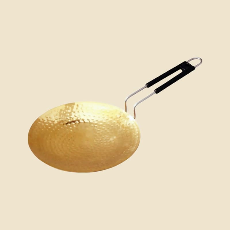 Brass Hammer Tawa on a warm ivory background