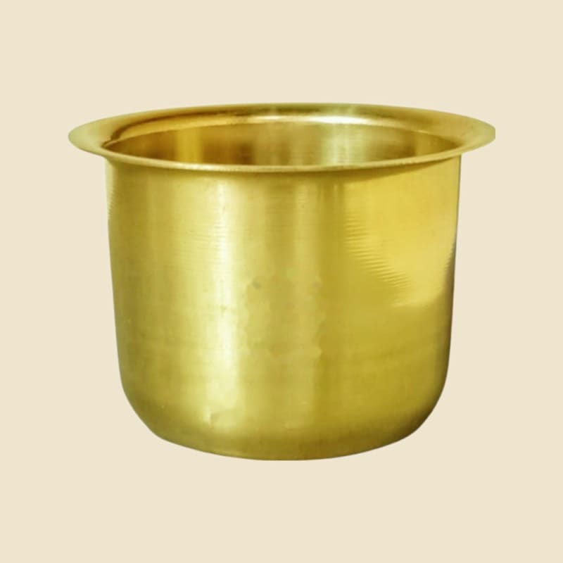 Brass Phool Patra on a warm ivory background