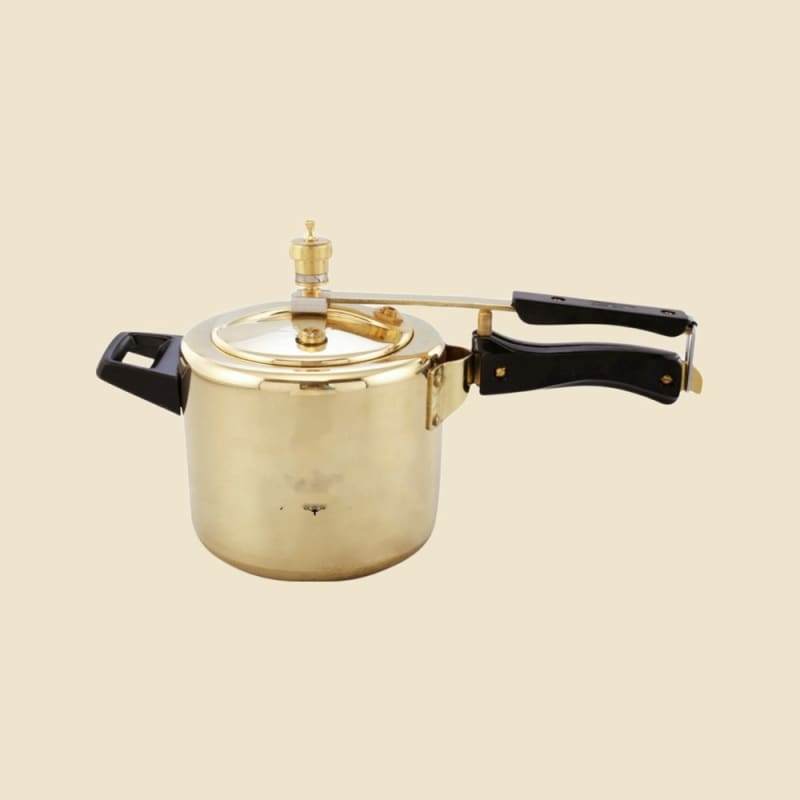 Brass Pressure Cooker, Inner Kalai on a warm ivory background