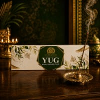Close-up of Yug herbal incense stick — green botanical masala coating on bamboo core