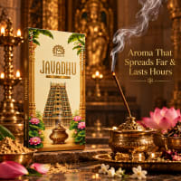Javadhu incense burning in a brass holder beside the slim box