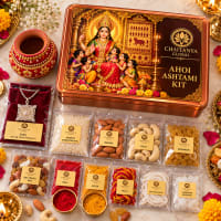 Close-up of Ahoi items — pendant, kumkum, akshat, mishri