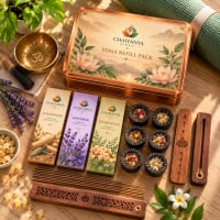 Flat lay of incense packs, sambrani dhoop cups and carved wooden holders beside a yoga mat
