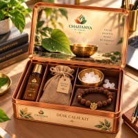 Open tin showing calm roll-on, vetiver root sachet, brass bowl of kapoor and rudraksha wrist mala