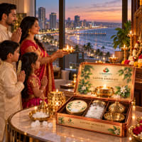 Family performing aarti with the Kapoor Aroma Kit overlooking the sea at sunset