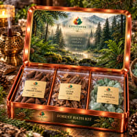 Open tin showing pine dhoop cones, cedar bark and green aventurine pouches