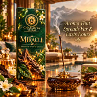Miracle incense stick burning in a brass holder beside the slim box