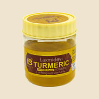 Laxmidevi Turmeric Powder 50 g jar on a warm ivory background