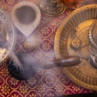 Loban burner smoking on a brass tray in a festive setting