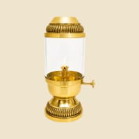 Brass Akhand Diya with Glass Chimney on a warm ivory background