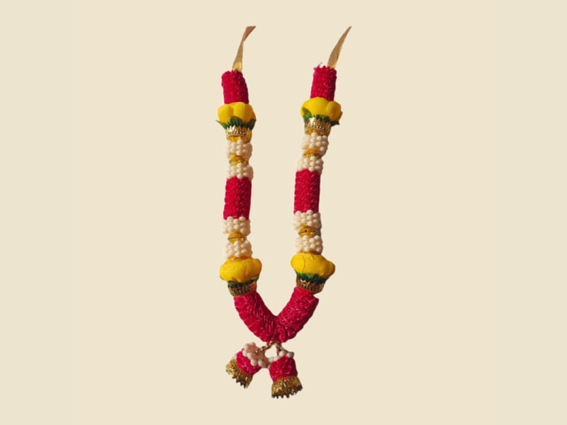 Festive red and pink deity mala with yellow flowers and pearls