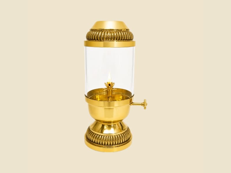 Brass Akhand Diya with Glass Chimney on a warm ivory background