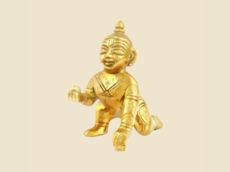 Brass Laddu Gopal, Smiling Face, Plain Finish on a warm ivory background