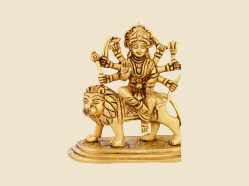 Brass Durga on Lion, Oval Base on a warm ivory background