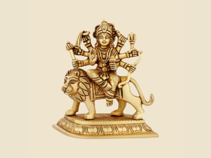 Brass Durga on Lion, Rectangular Base on a warm ivory background