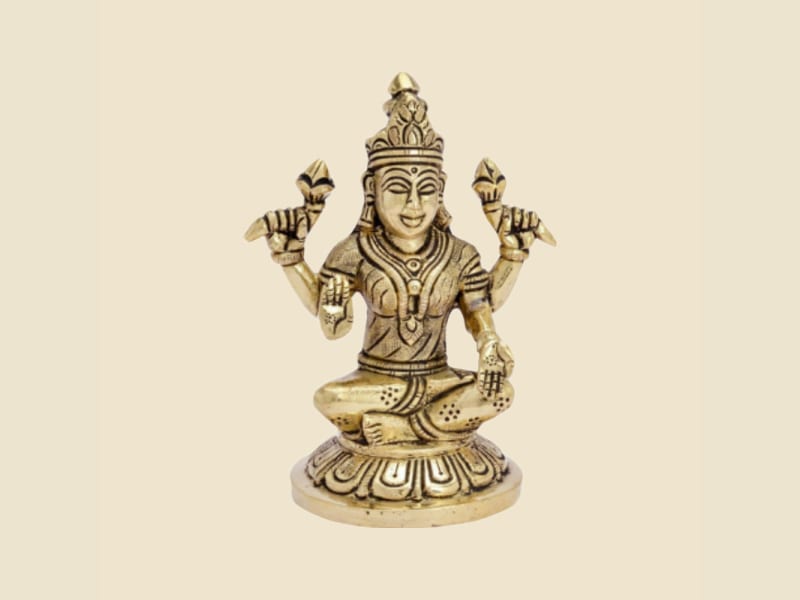 Brass Lakshmi Seated on Round Lotus Base on a warm ivory background