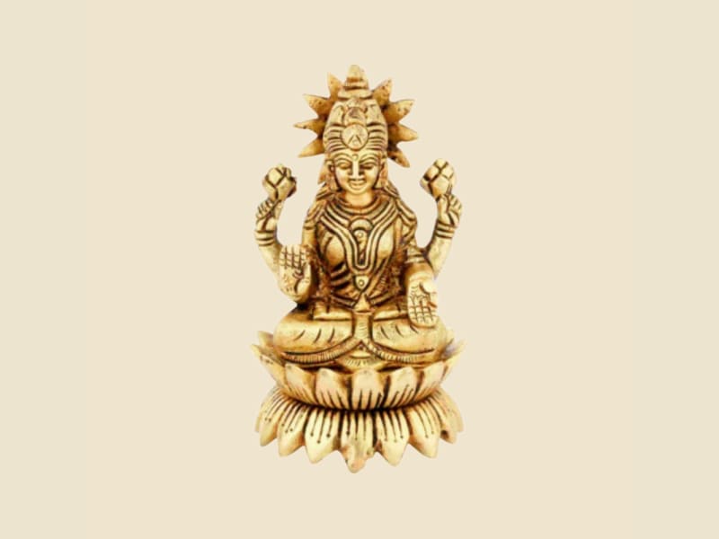 Brass Lakshmi with Sunburst Crown on a warm ivory background