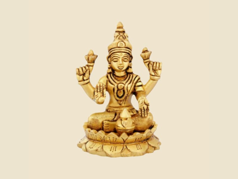 Brass Lakshmi Seated on a warm ivory background