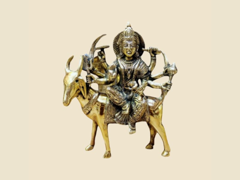 Brass Multi-armed Goddess on Bull on a warm ivory background