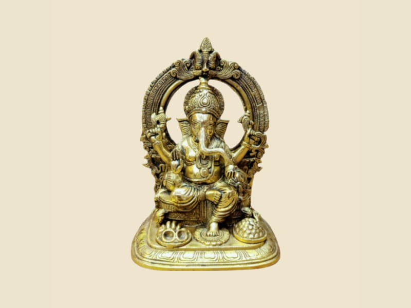Brass Ganesha under Arch on a warm ivory background