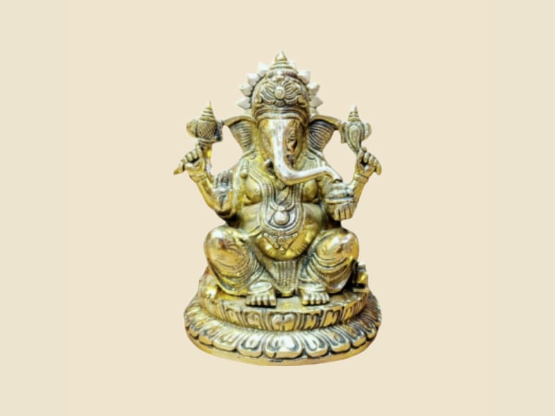 Brass Ganesha Seated on Lotus Base on a warm ivory background