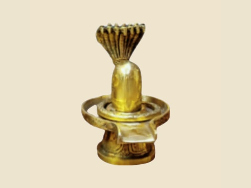 Small Brass Shivling on a warm ivory background
