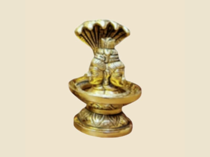 Small Brass Shivling with Serpent on a warm ivory background