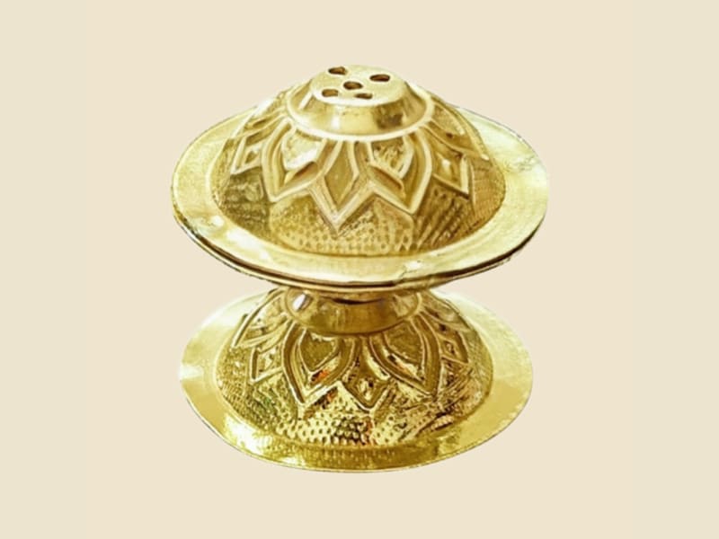 Brass Nakshi Agardan on a warm ivory background