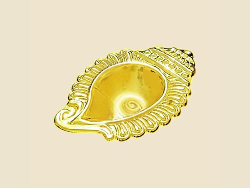Brass Shankh Chirag on a warm ivory background