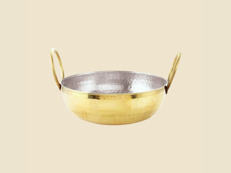 Brass Kalai Hammered Kadhai on a warm ivory background