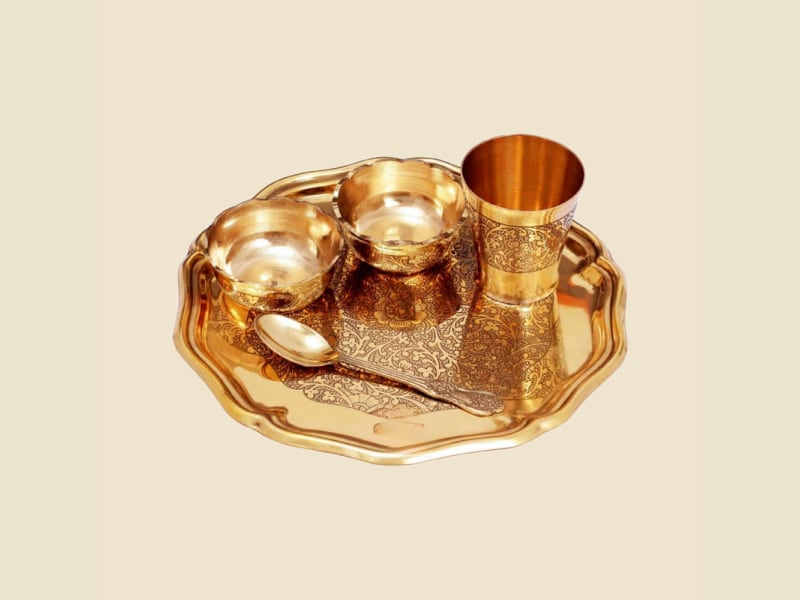 Brass Etching Laddu Gopal Bhog Set on a warm ivory background