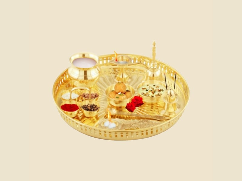 10-piece Brass Puja Thali Set on a warm ivory background