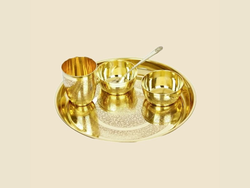 Brass Apple Etching Thali Set on a warm ivory background