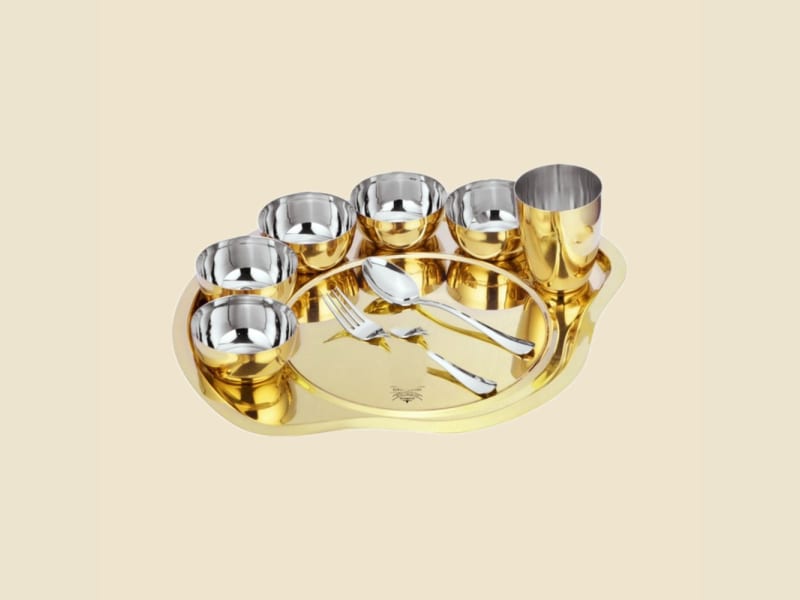 Steel and Brass Compartment Thali Set on a warm ivory background