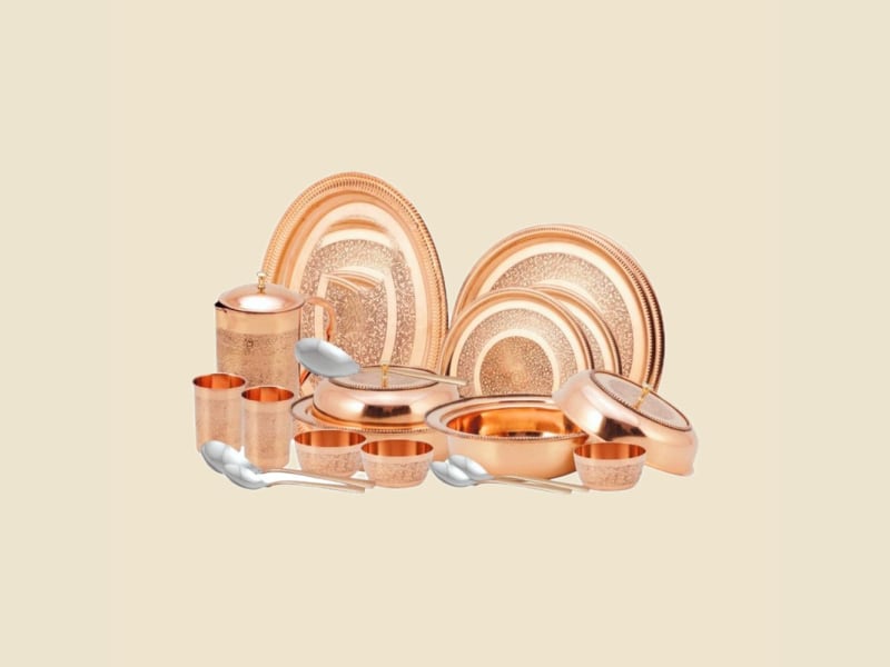 Etched Copper Dinner Set on a warm ivory background