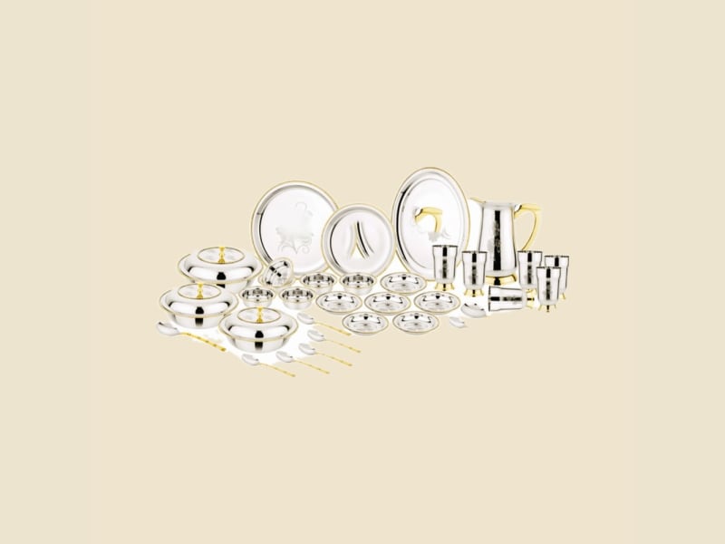 Steel Dinner Set with Gold Accents on a warm ivory background