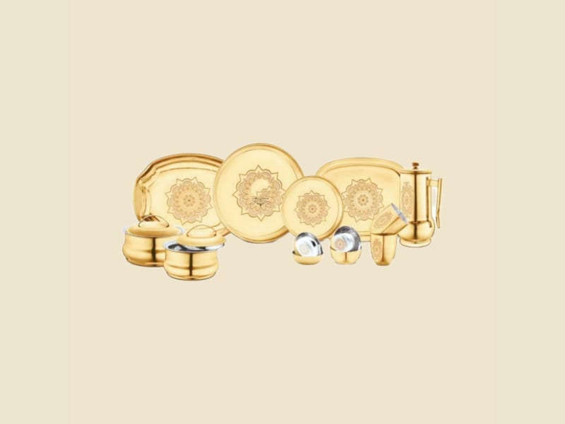 Etched Brass Dinner Set on a warm ivory background