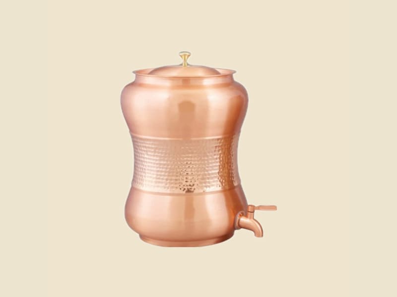 Hammered Copper Waisted Water Dispenser on a warm ivory background