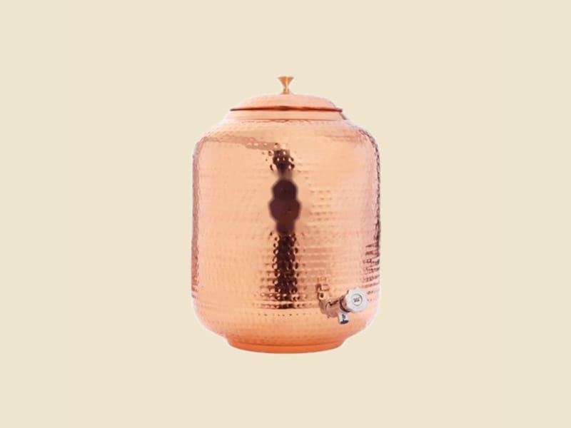 Hammered Copper Water Dispenser, Round on a warm ivory background