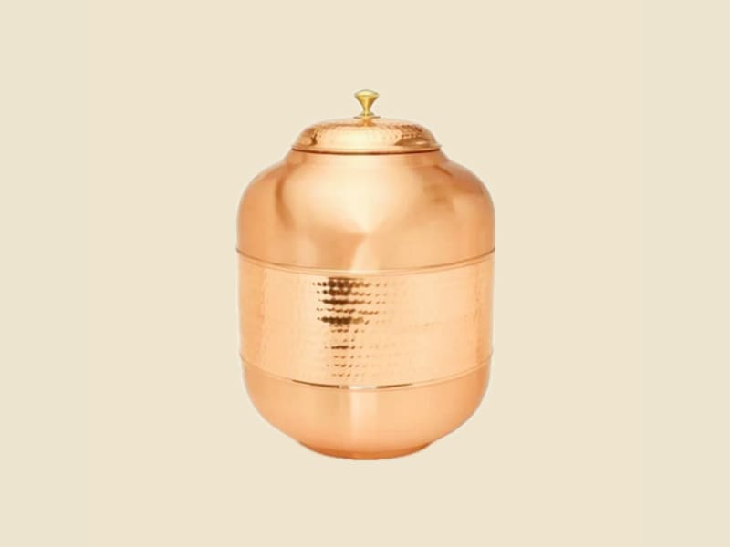 Half-Hammered Copper Water Dispenser on a warm ivory background