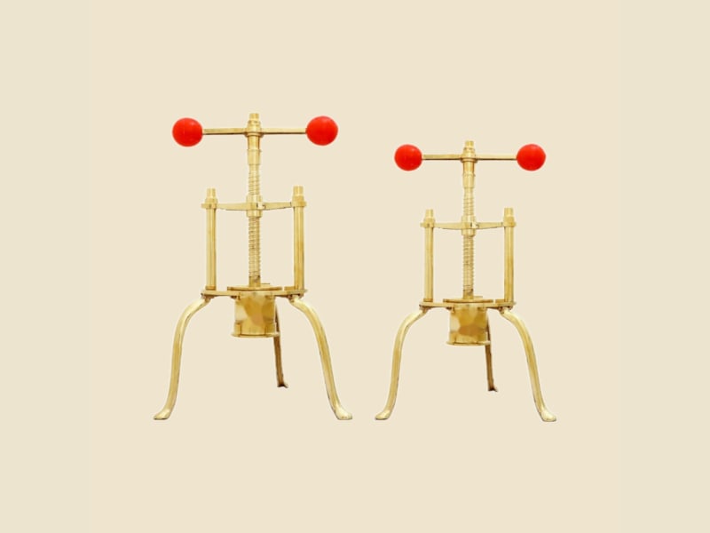 Brass Sevga (Sev Press) on a warm ivory background
